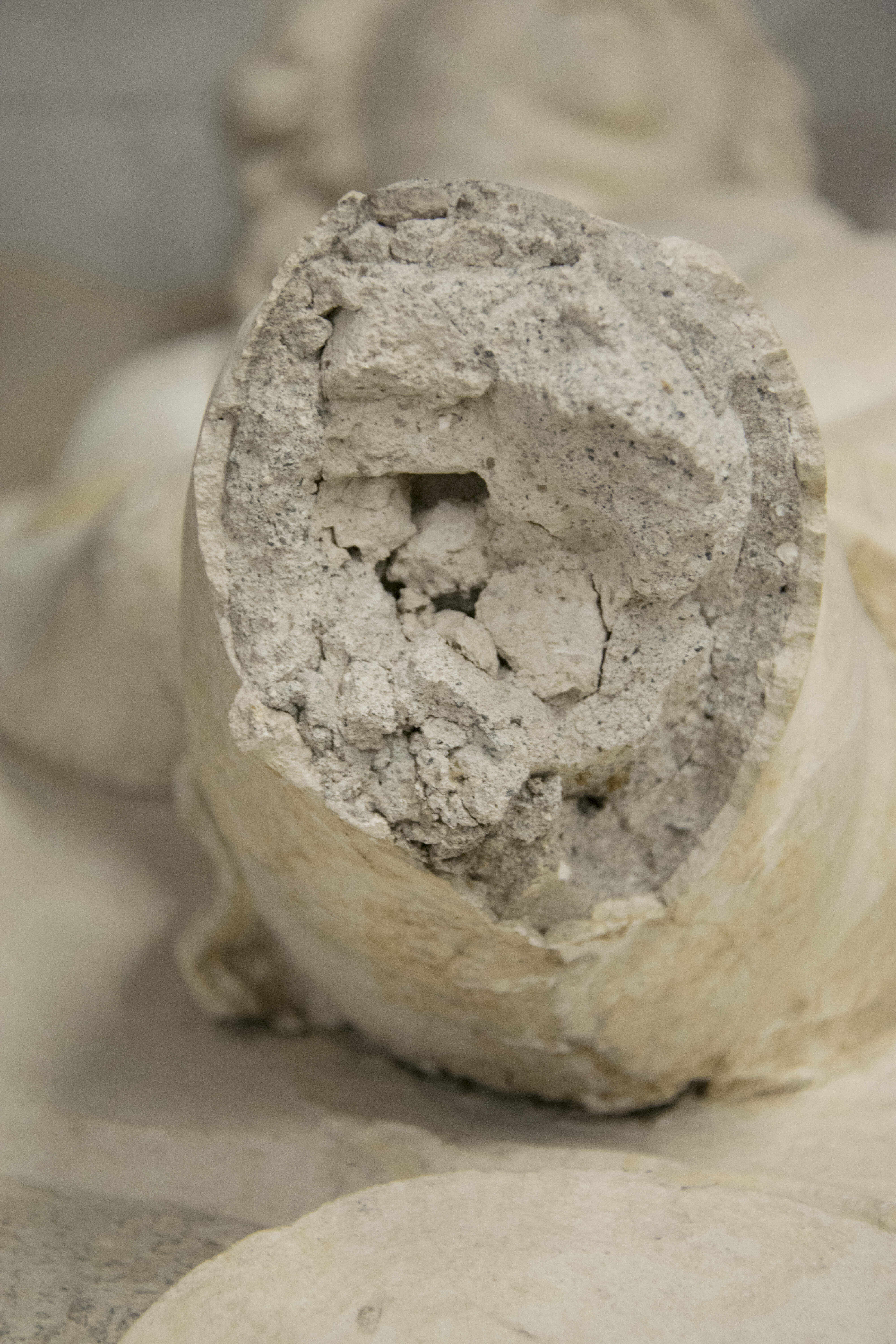 Detail of a deteriorated stucco decoration. The missing part of the decoration exposes a coarse white layer composed of lime and gypsum, a second coarse layer and a bright white finishing layer.