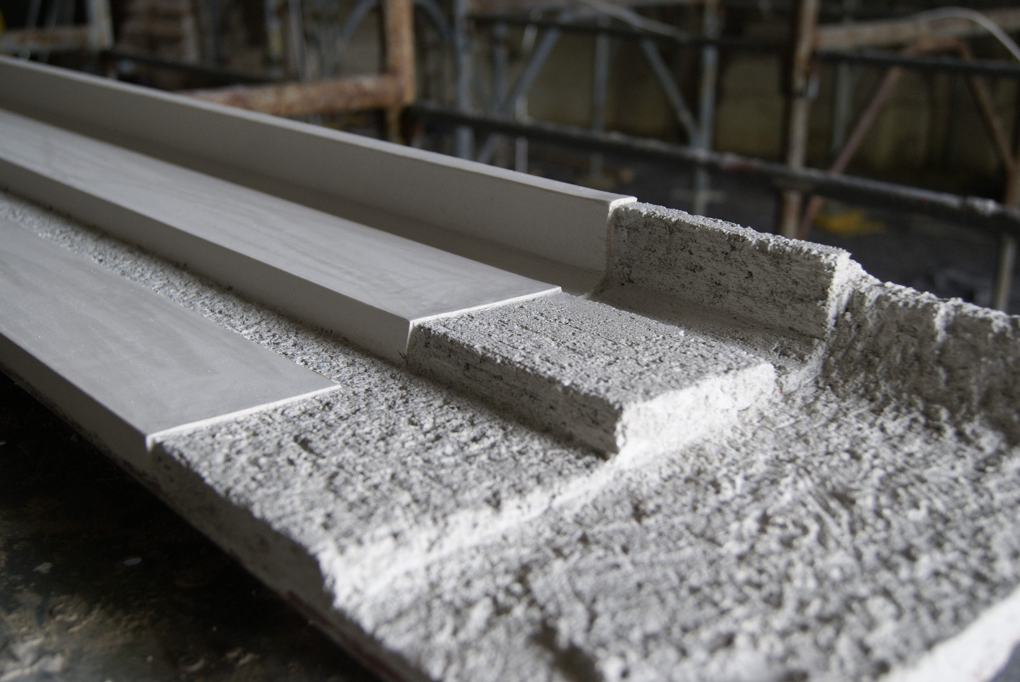 Stages of creating a decorated corniche using a press mould.