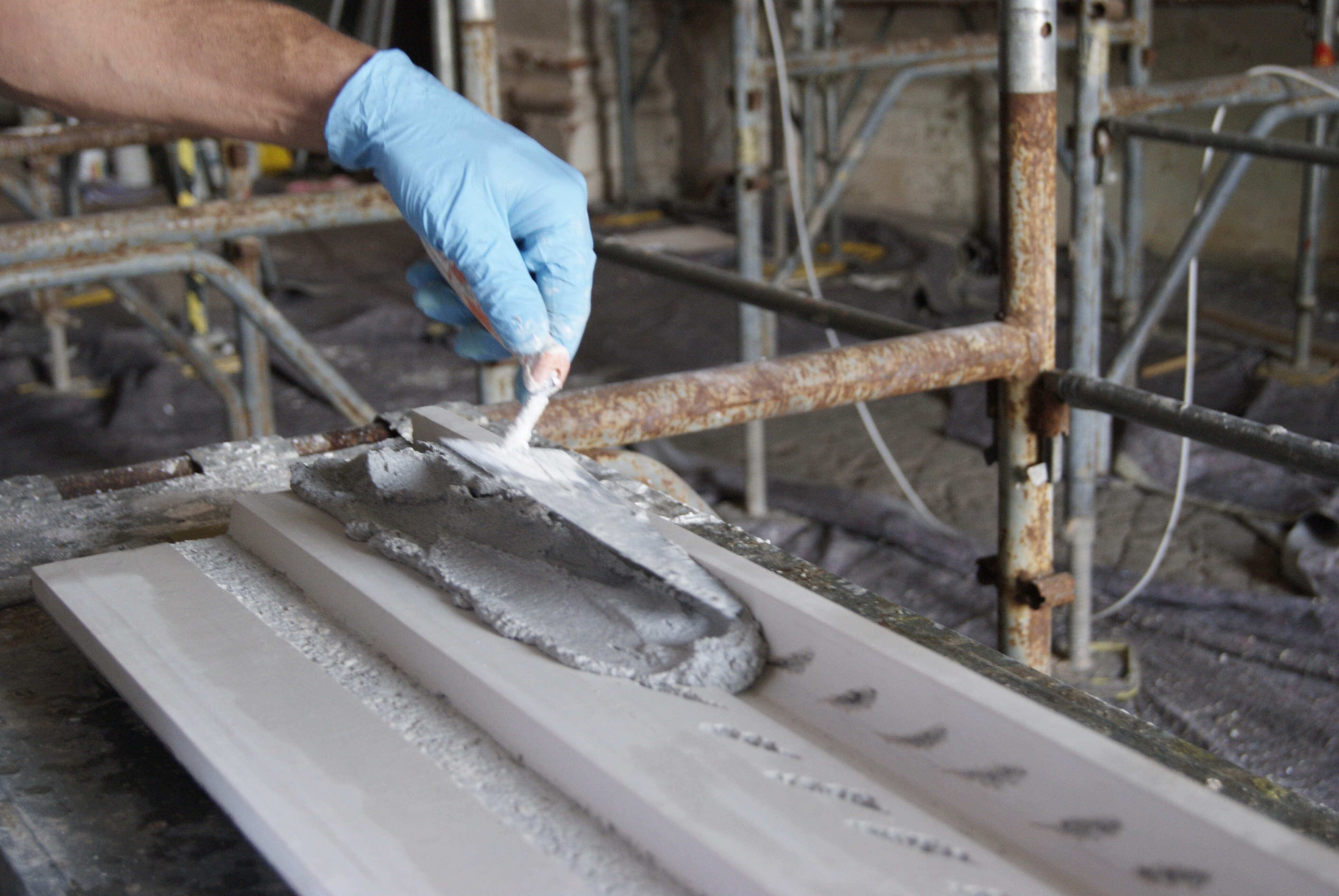 Stages of creating a decorated corniche using a press mould.