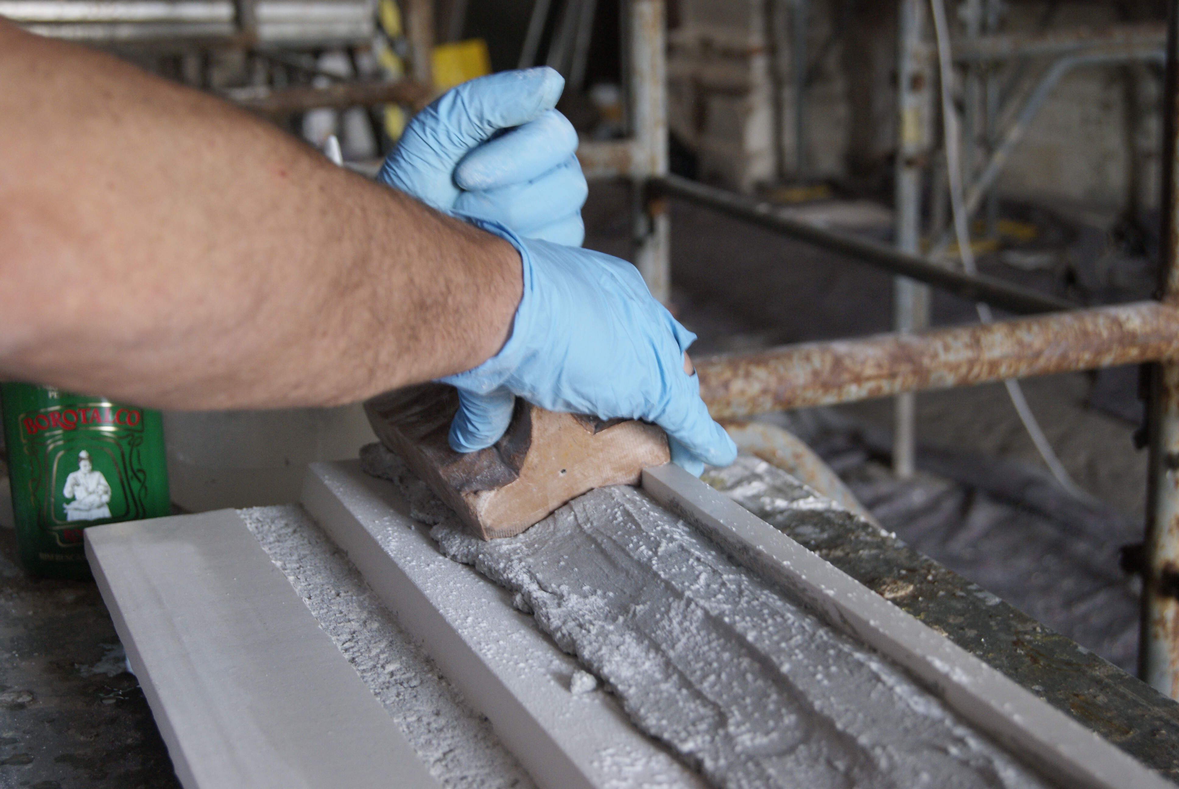 Stages of creating a decorated corniche using a press mould.