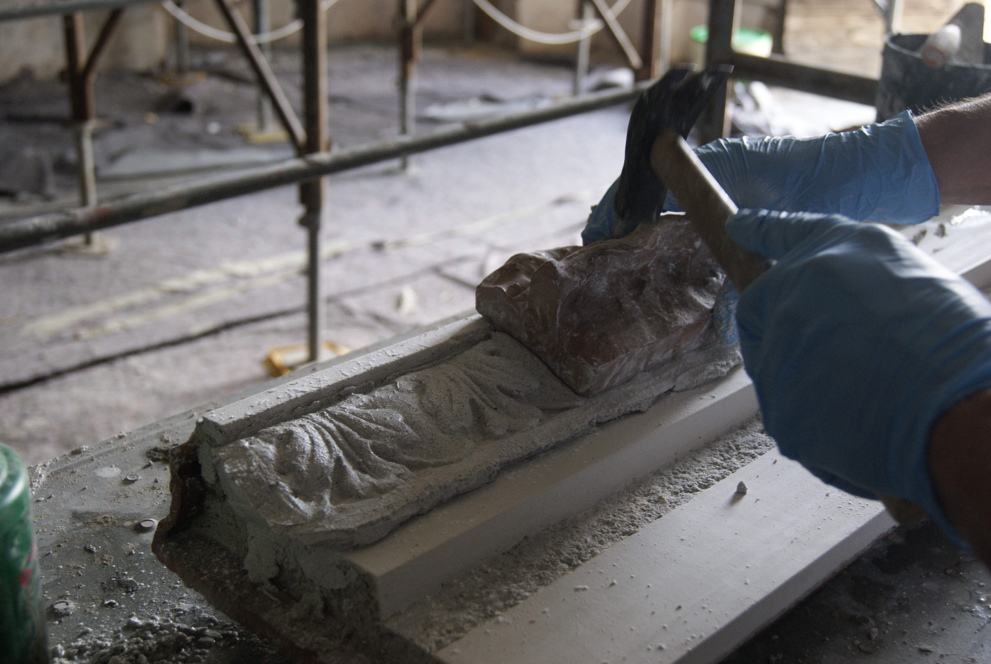 Stages of creating a decorated corniche using a press mould.