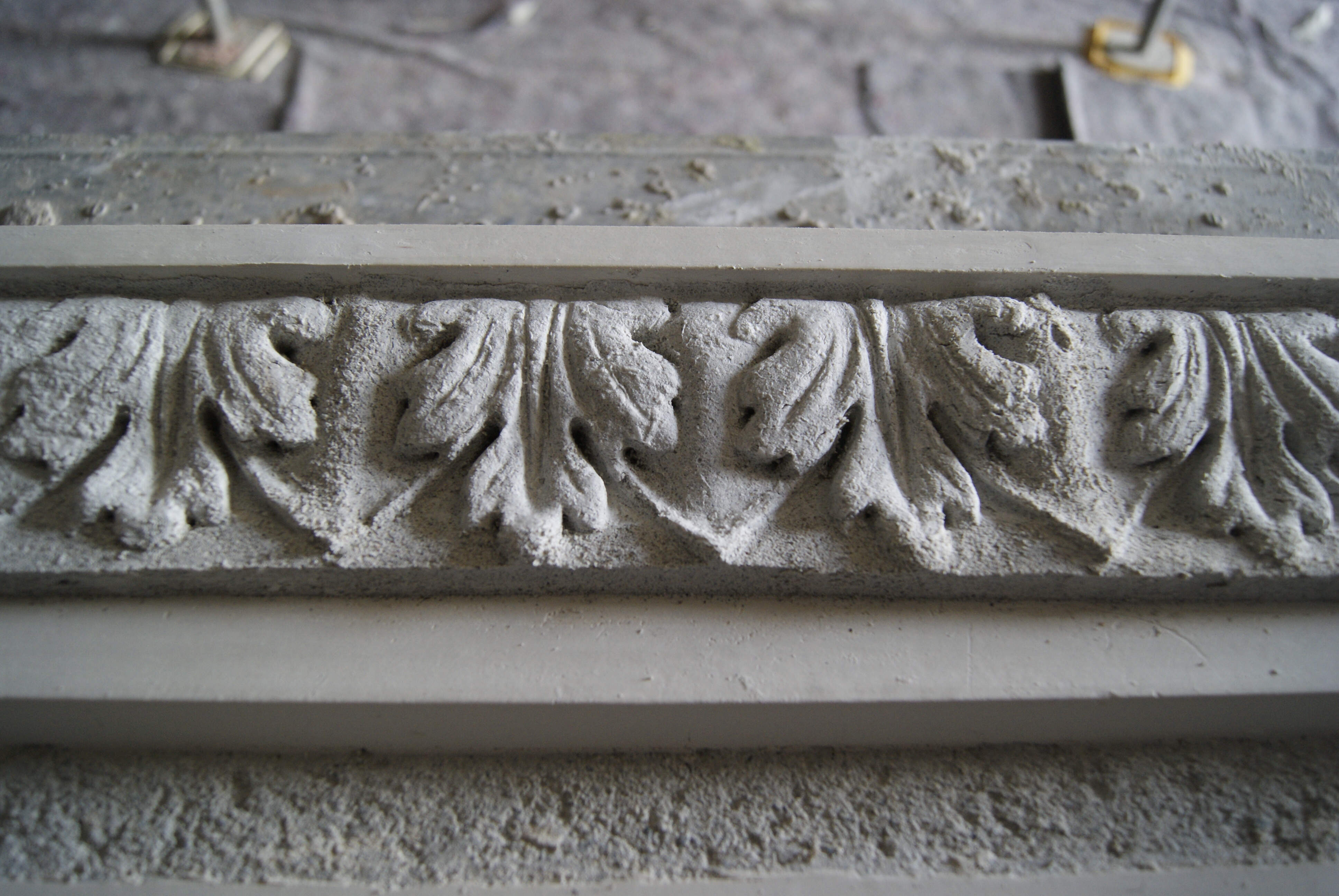 Stages of creating a decorated corniche using a press mould.