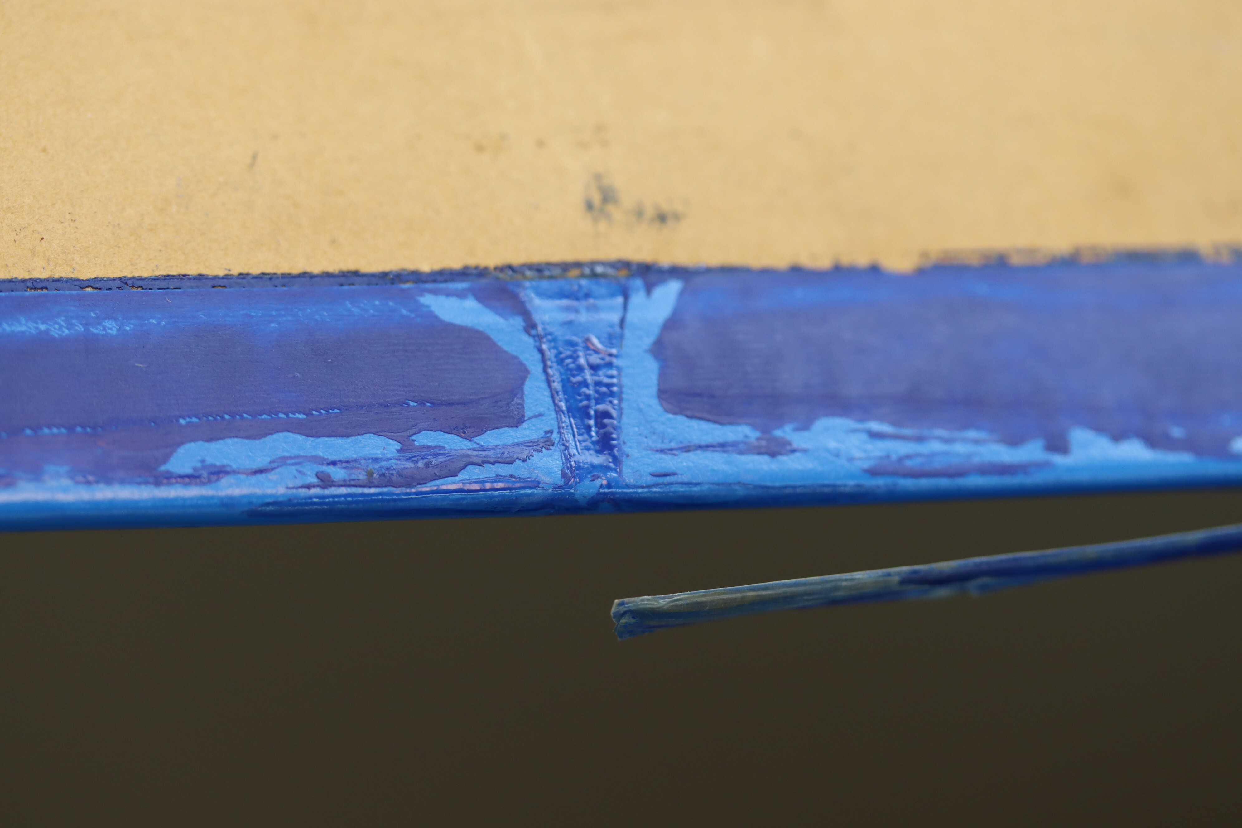 Close-up showing a detail of the blue-painted PVC tape on the first-floor plan.