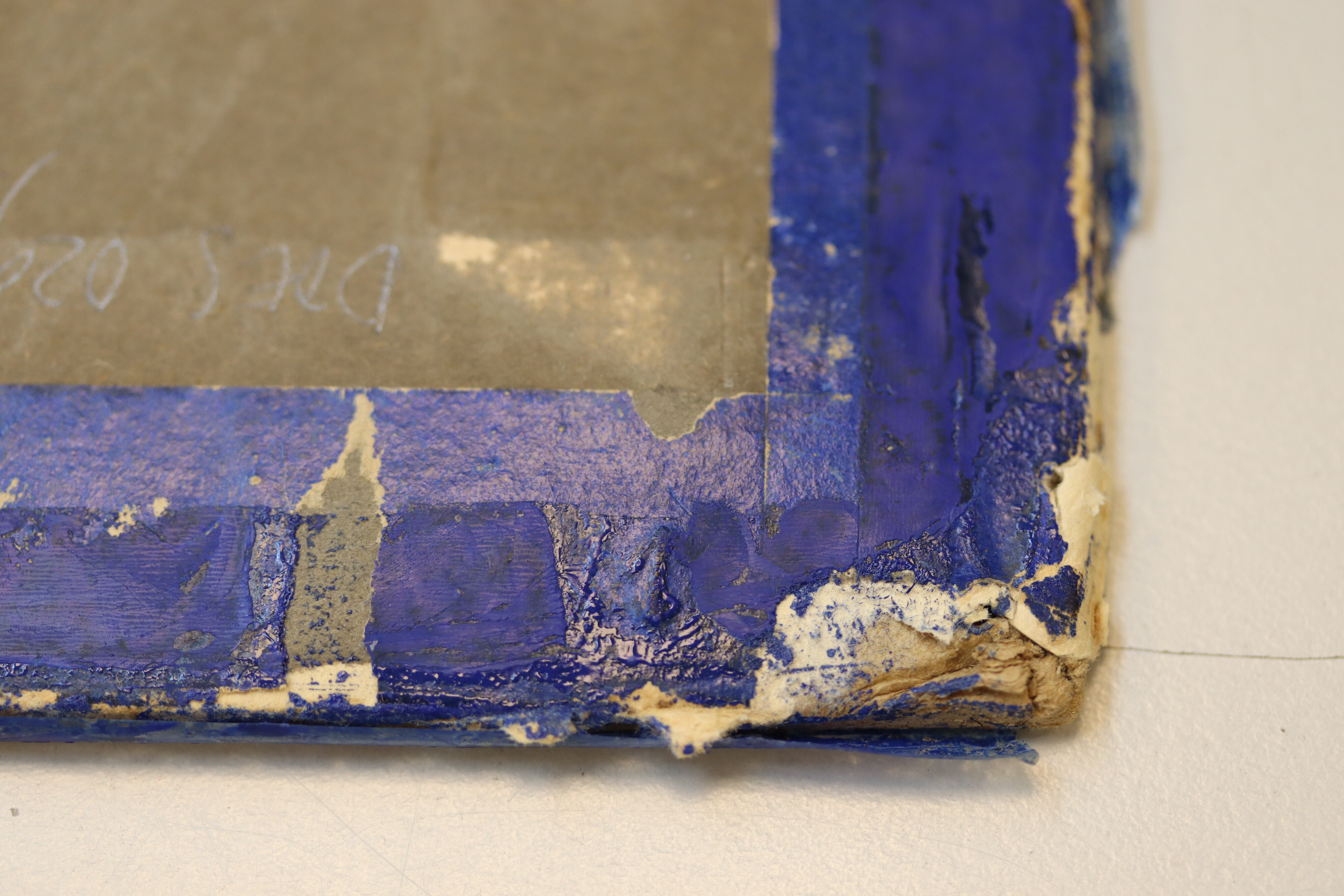 Close-up of the upper left corner of the backside of the second-floor plan of Maison Particulière, showing transparent pressure-sensitive tape and blue paint on blue-glazed paper.
